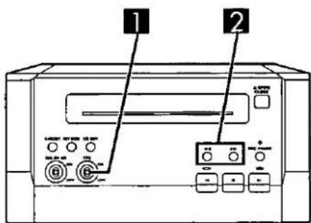 Diagram of a computer front panel with labeled buttons and ports, showing two numbered components.