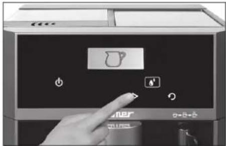 Close-up of a hand pressing a coffee maker control panel with icons and labels