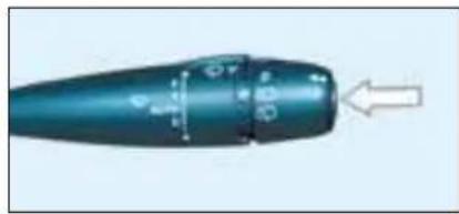 Close-up of a teal-colored mechanical component with a white arrow pointing to it (no visible text or symbols)