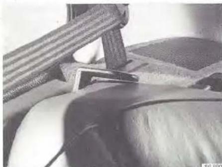 Close-up of a mechanical component with textured surfaces and a small rectangular object, no visible text or symbols.