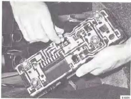 Close-up of hands installing or adjusting a circuit board component (no visible text or symbols)