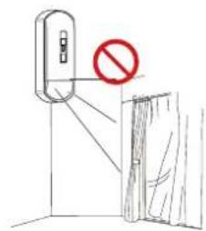 Diagram showing a device with a red prohibition symbol and a person standing near curtains, likely indicating no protection or absence.