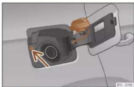 Diagram of a camera module being inserted into a car, showing the lens and cable (no text or symbols present)