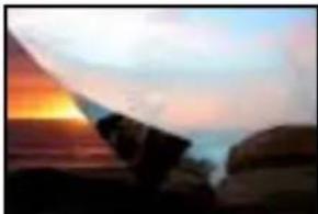 Silhouette of a person standing at sunset with a flag partially visible (no text or symbols)