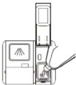 Line drawing of a hand inserting a device into a device with a screen and cable (no text or symbols)