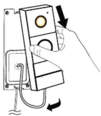 Hand holding a device with a circular button and directional arrows indicating rotation or adjustment (no text or symbols)