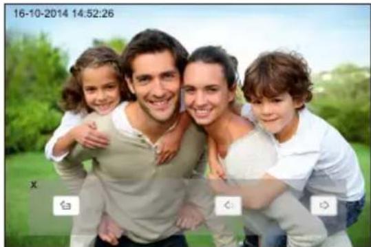 Family photo of four smiling adults and two children outdoors, with greenery and date stamp overlay (no readable text in image)