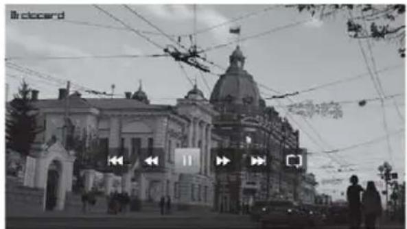 Black-and-white street photo showing a historic building with a large dome and illuminated windows, overlaid with directional arrows and a play button.