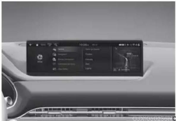 Interior view of a car dashboard with digital display showing app icons and navigation tabs