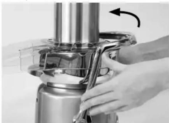 Close-up of hands operating a stainless steel industrial blender with a curved arrow indicating rotation (no text or symbols visible)