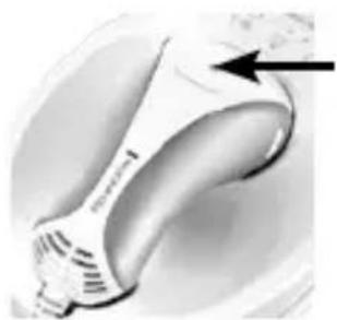 Close-up of a white ergonomic device with a black arrow pointing to the handle (no visible text or symbols)