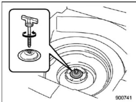 Technical diagram showing a mechanical assembly with a labeled component and an inset view of a tool interacting with a central component.