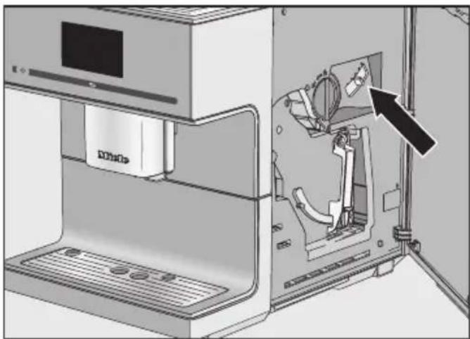 Interior view of a 3D printer showing internal components and a close-up of the device's base panel (no text or symbols visible)