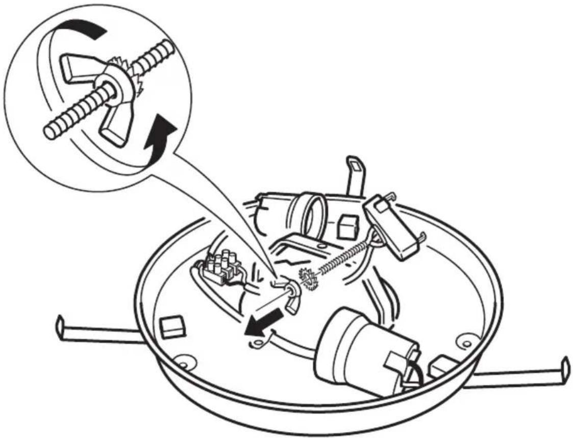 Diagram illustrating a mechanical device being processed in a pan, with an inset showing the internal mechanism and motion direction.