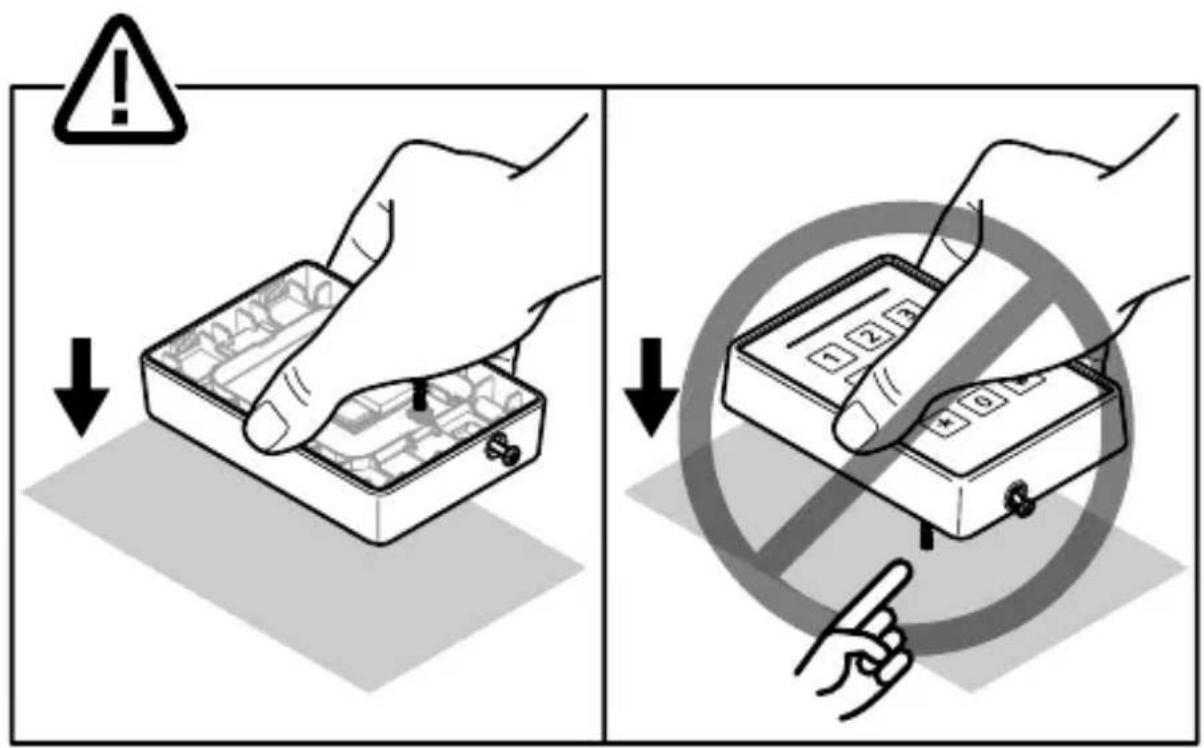 Safety warning illustration showing hand operating a device with warning symbols and a magnified view of the device's pad.