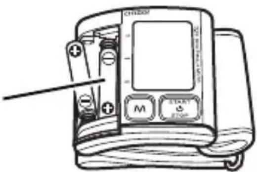 Diagram of a blood pressure monitor with labeled buttons and indicator lights, showing internal components and a pointer pointing to the screen.