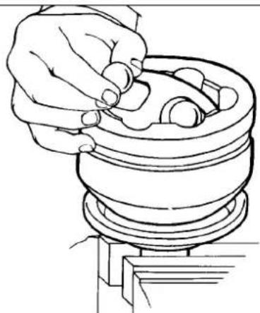 Line drawing of a hand adjusting a mechanical component (no text or symbols)