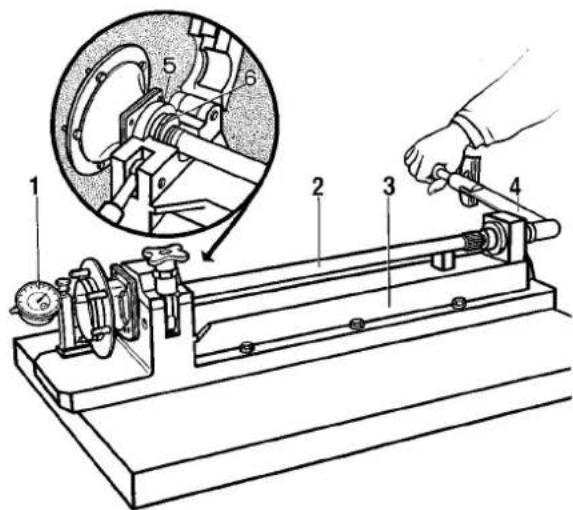 Technical diagram of a mechanical device with numbered components and an inset showing a close-up of a mechanical assembly.