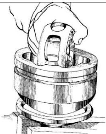 Technical illustration of a hand operating a mechanical component (no text or symbols visible)