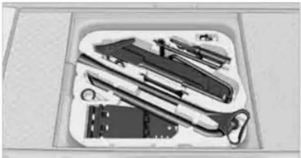 Black-and-white photo of a toolbox containing various kitchen utensils and tools (no visible text or labels)
