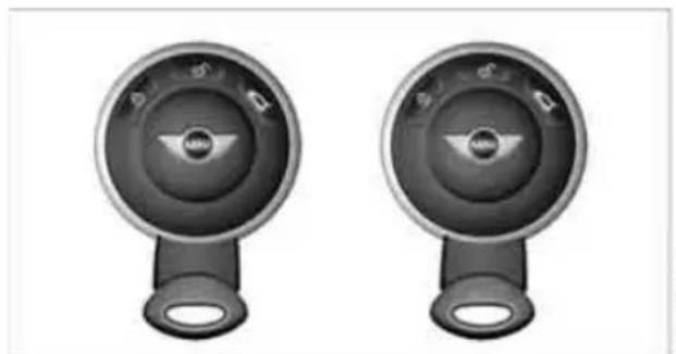 Two identical circular industrial control knobs with black and white buttons, no visible text or symbols