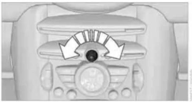 Top-down view of a car dashboard with directional arrows indicating airflow or movement (no text or symbols)