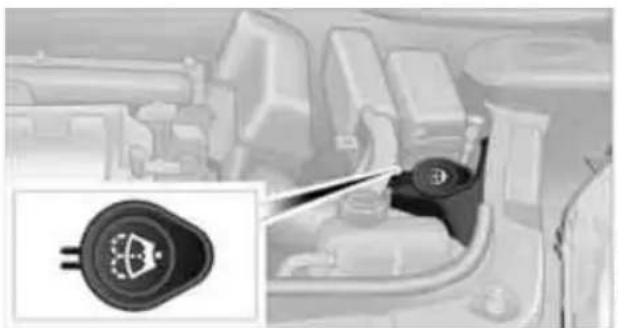 Interior view of a vehicle showing a close-up of the engine compartment with a close-up inset of the valve (no text or symbols visible)