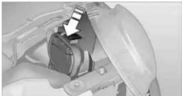 Close-up of a mechanical component with a white arrow pointing to a component (no visible text or symbols)