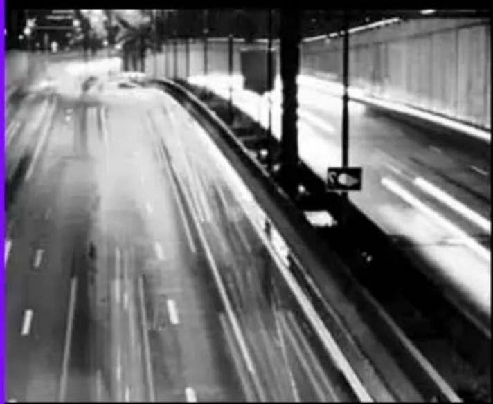 Black-and-white photo of a highway with motion blur, no visible text or symbols