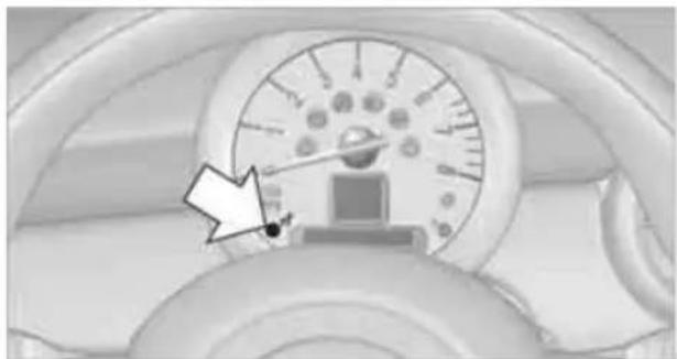 Close-up of a car dashboard with a speedometer and circular dial indicator (no visible text or symbols)