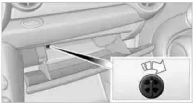 Interior view of a car showing the intake manifold and a close-up of a plug with a circular connector (no text or symbols visible)