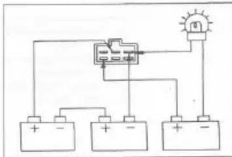 Electrical circuit diagram showing a battery, switch, and lamp connected to three batteries with polarity labels