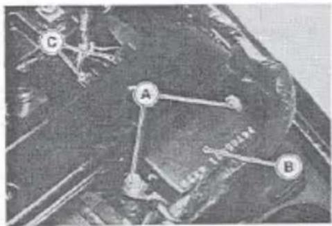 Black-and-white photo of a mechanical or electrical component with labeled points A, B, and C indicating specific components.