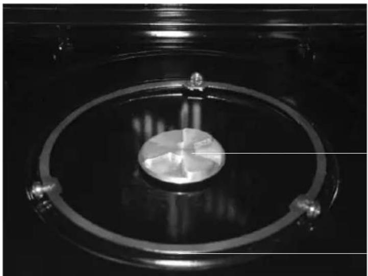 Close-up of a circular transparent object with internal markings, possibly a scientific instrument or component (no visible text or symbols)