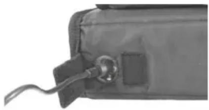 Close-up of a black medical or electronic device with a small connector and cable (no visible text or symbols)