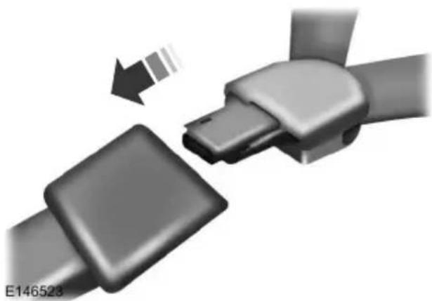 Close-up of a mechanical belt buckle assembly with a magnified inset showing a section detail (no text or symbols visible)