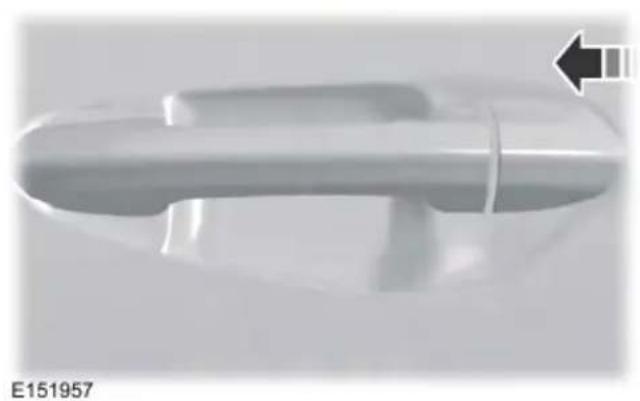 Close-up of a metallic handle with a black arrow pointing to it, no visible text or symbols on the object itself.