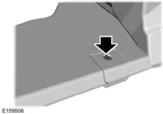 Close-up of a mechanical component with a black arrow pointing to a small feature, no visible text or symbols.