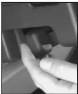 Close-up of a hand pressing a button on a mechanical component (no visible text or symbols)