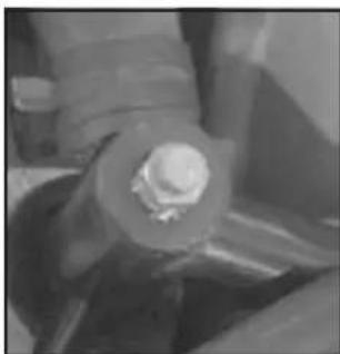 Close-up of a hand holding a small white object, possibly a mechanical component or tool, with no visible text or symbols.