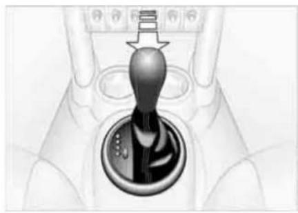 Close-up of a hand holding a car gear shift lever (no text or symbols visible)