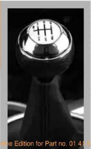 Close-up of a metallic gear switch with a circular head and cross symbol (no text or symbols on the component itself)