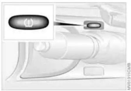 Close-up of a car interior with a highlighted button and pipe fitting (no text or symbols visible)