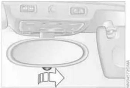 Interior view of a car showing the dashboard and seat area with a directional arrow (no text or symbols)