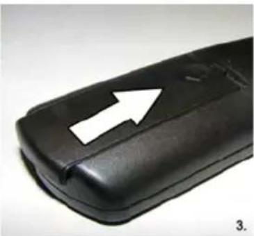 Close-up of a black plastic object with a white arrow pointing to a side edge (no text or symbols visible)