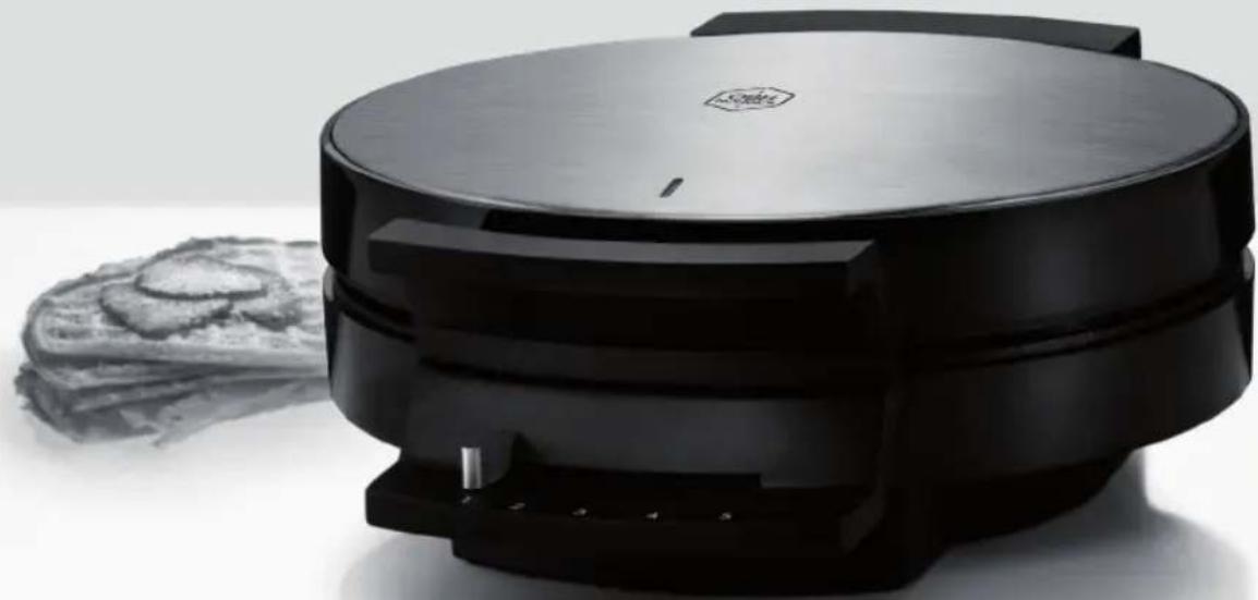 Black square waffle grater with a flat lid, next to a flat plate of bread slices (no text or symbols visible)