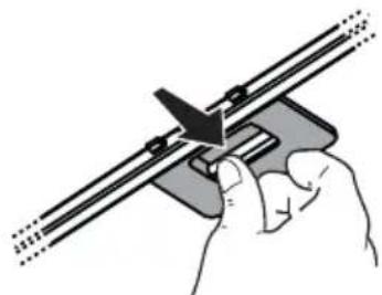 Hand holding a mechanical tool with a cutting board (no text or symbols visible)