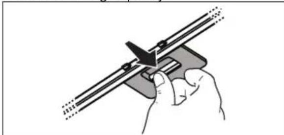Hand holding a mechanical tool with a triangular component inserted, no visible text or symbols