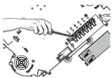 Technical diagram showing a hand using a screwdriver to adjust components on a mechanical assembly, with visible part numbers and labels.