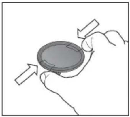 Hand holding a circular object with directional arrows indicating rotation or movement (no text or symbols)